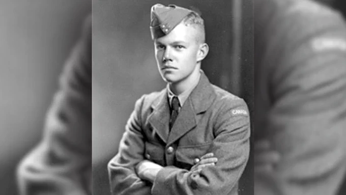 Black and white photograph of Rifleman James Clinton Wheeler in uniform, with his hands crossed.