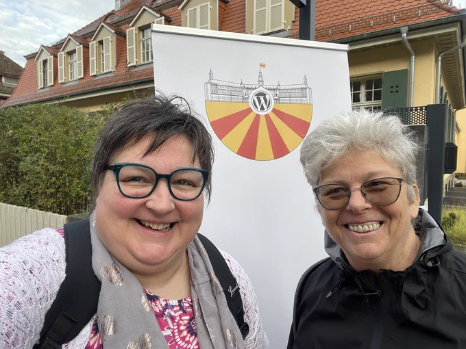 Two gorgeous middle-aged women smiling into the camera