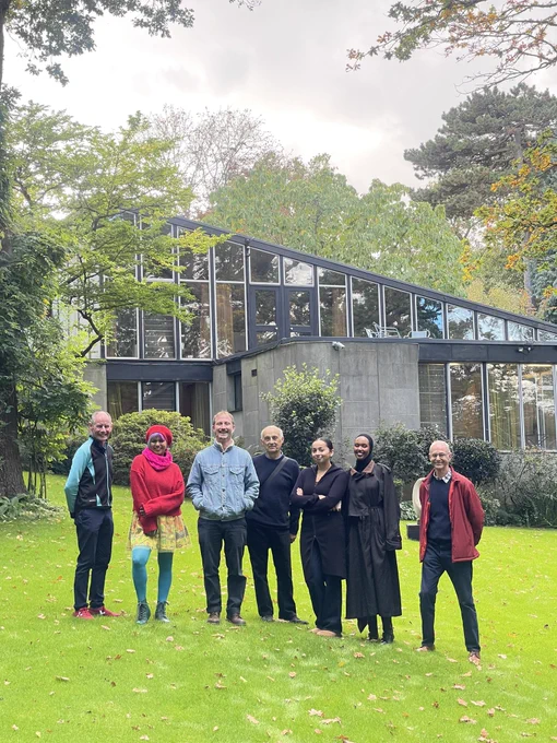 Members of the team in garden outside the house
