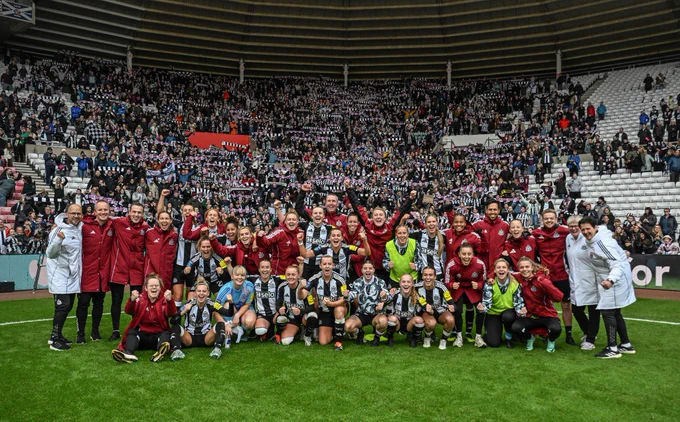 The team have their team photo in front of the away end!