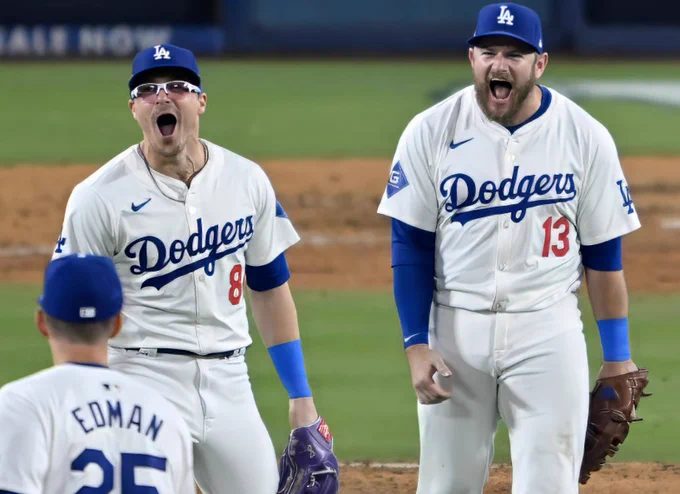 Kiké Hernández, Max Muncy, and Tommy Edman celebrate the Dodgers winning NLDS Game 5