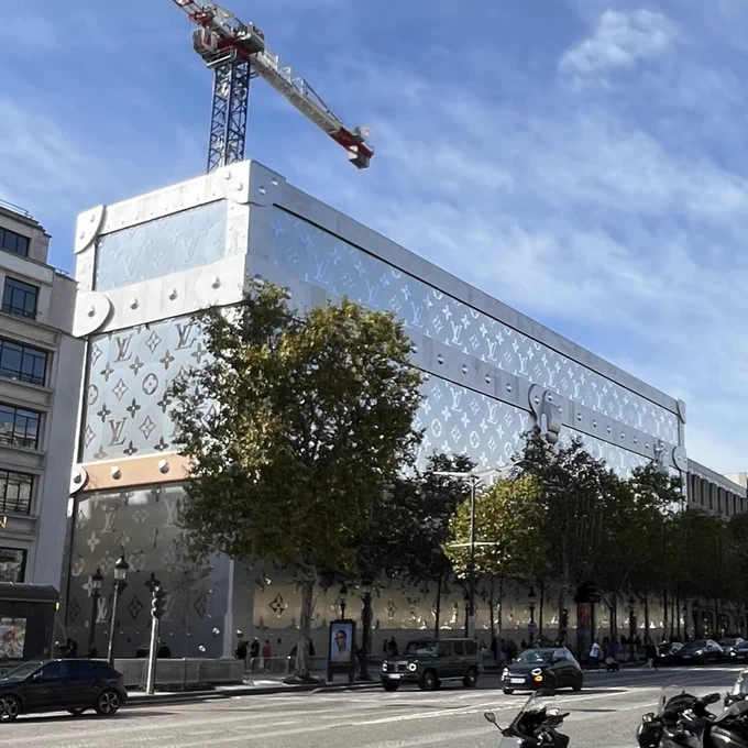 The site on the Champs Elysées in Paris where a new Louis Vuitton store is being built. It’s surrounded by a giant silvery fake LV case, five storeys high. There are even big locks on the lid.