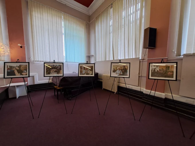 Colour photograph showing photographs on display