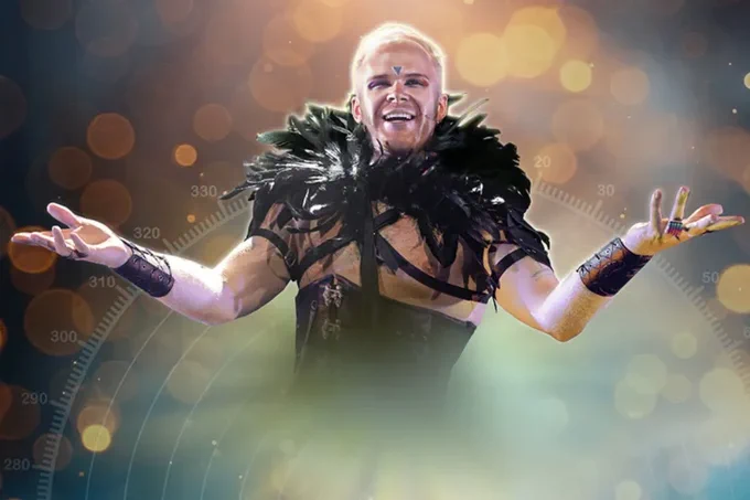 Christian Lunn in Grindr The Opera - he wears a black corset and feathers