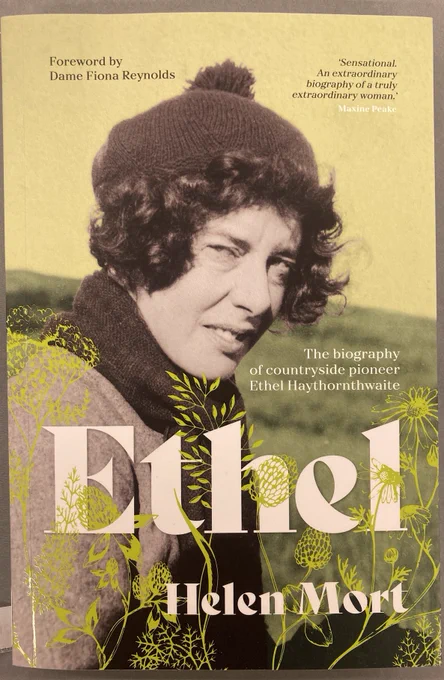 Front cover of the book 'Ethel' by Helen Mort. On a pale green background is a black and white photo of a woman with short curly hair, wearing a woolly hat. 