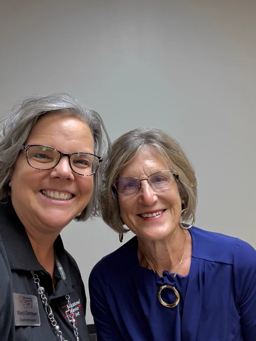 ESU 7 Chief Administrator standing with a board member