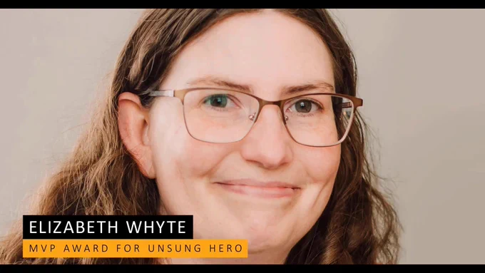 Headshot of Elizabeth wearing glasses and looking happy
