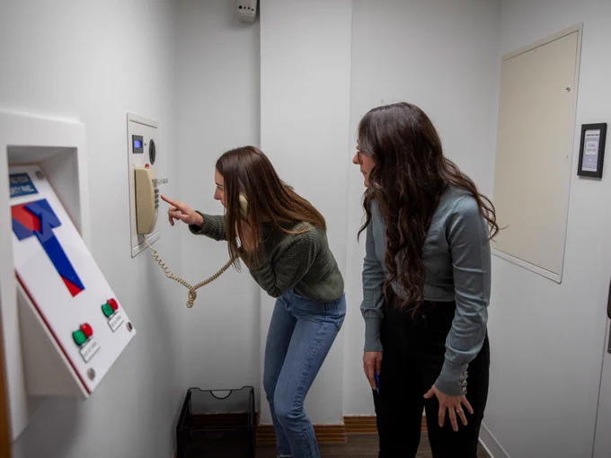 Two individuals interacting with an escape room.