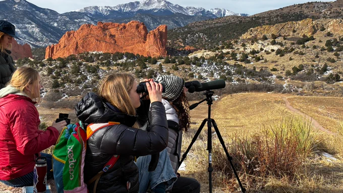With Pikes Peak in the distance, students look to right on optics to observe bighorn sheep