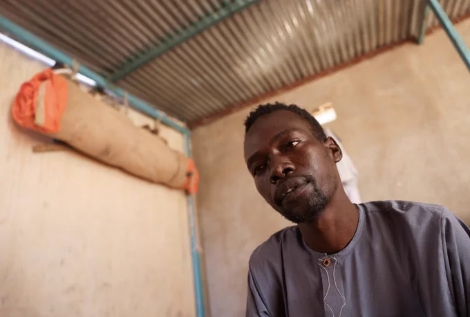Abdulmajeed Abdulkarim, 28, a Sudanese refugee who heard small children crying at night for their parents while he was held captive by paramilitary Rapid Support Forces (RSF) fighters outside of al-Fashir, during an interview with Reuters in Tine, Chad November 24, 2025. REUTERS/Amr Abdallah Dalsh
