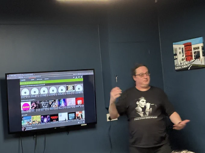 Tom presenting, aside screen