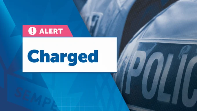 On the left side, a pink and white box with a warning icon and the word "ALERT" is displayed prominently. Below it, a large white box contains the word "Charged" in bold blue letters. The right side of the image features a blue-tinted, slightly blurred photograph of a police officer's uniform with the word "POLICE" visible.