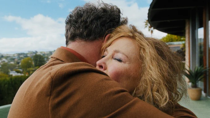 A frame from Episode 1 of The Studio, "The Promotion." Seth Rogen embraces Catherine O'Hara in a hug.