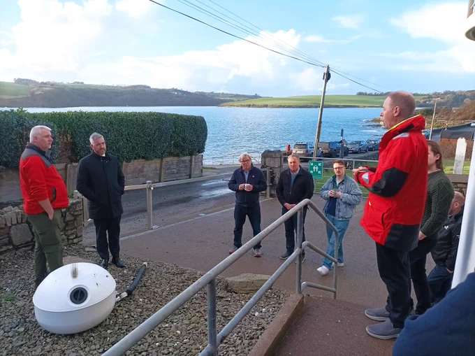 Minister Christopher O'Sullivan visits Cork Sub Aqua Cork in Oysterhaven Bay. Group photo outside with the Bay in the background.