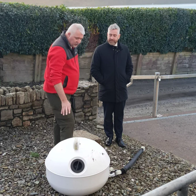 Representative of Cork Sub Aqua Group showing Minister O'Sullivan a special mooring funding by the Community Water Development Fund to help protect seagrass in the Oysterhaven Bay.
