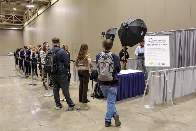 Attendees lining up for the headshot studio at the 105th Annual meeting.