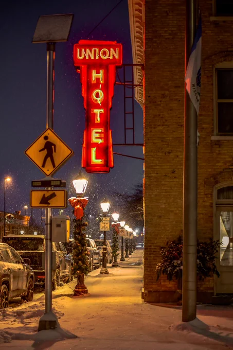 Union Hotel sign at night with snow falling