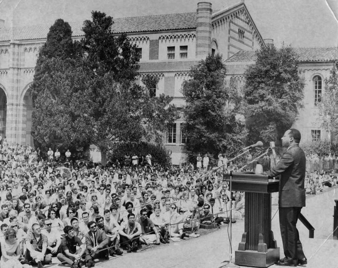 Martin Luther King speaks to a crowd of 4,500 on the campus of the University of California, Los Angeles. Here, he called for students to join a "Domestic Freedom Corps" to work in 120 counties of the Deep South to help increase the number of registered African American voters.