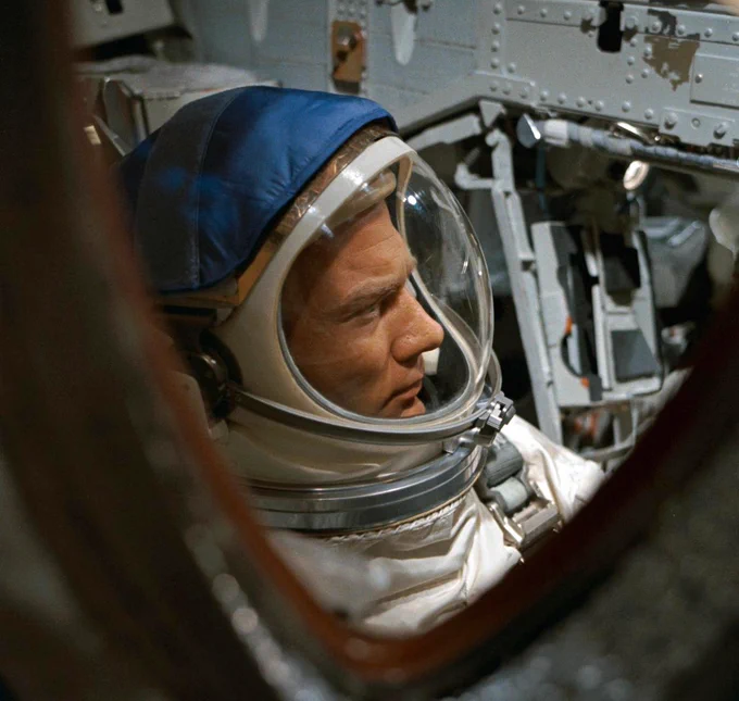 Photo of Buzz Aldrin wearing a spacesuit as seen through the window of the Gemini XII spacecraft on November 11, 1966.