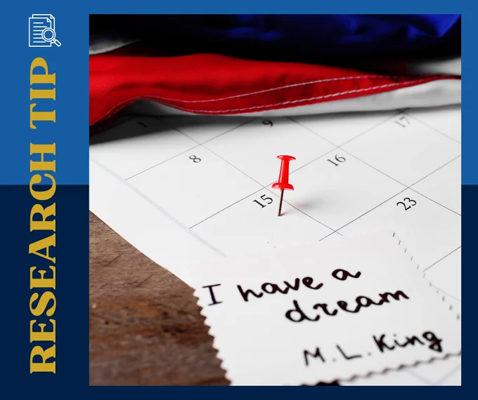 A calendar with a red pushpin in a date box and a note on top that reads I have a dream signed M L King.