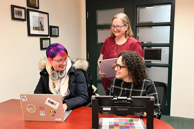 Sidney Hubbard, left, and Ola Fakhry, right, with Nancy Waite at Mills Memorial Library.