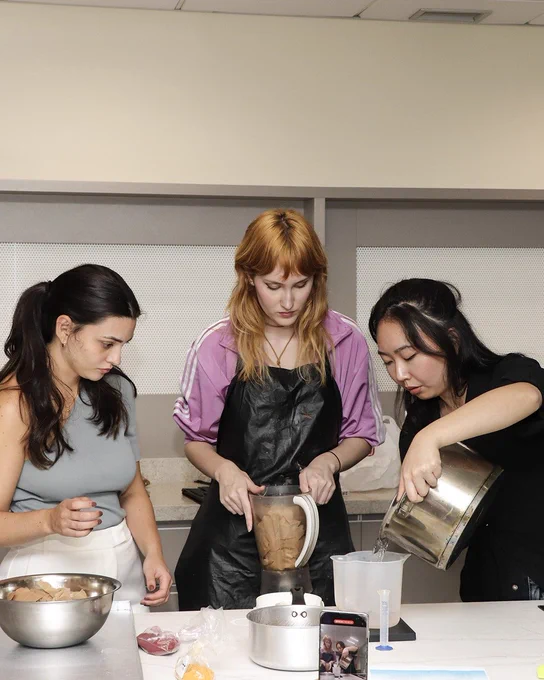 Three people participating in a workshop at the DesignTO festival. 