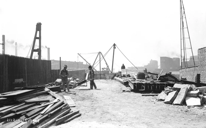A view from a point north of the construction site for a bridge at Canal Street on May 29, 1902, looking south at bridge construction materials and activity. 