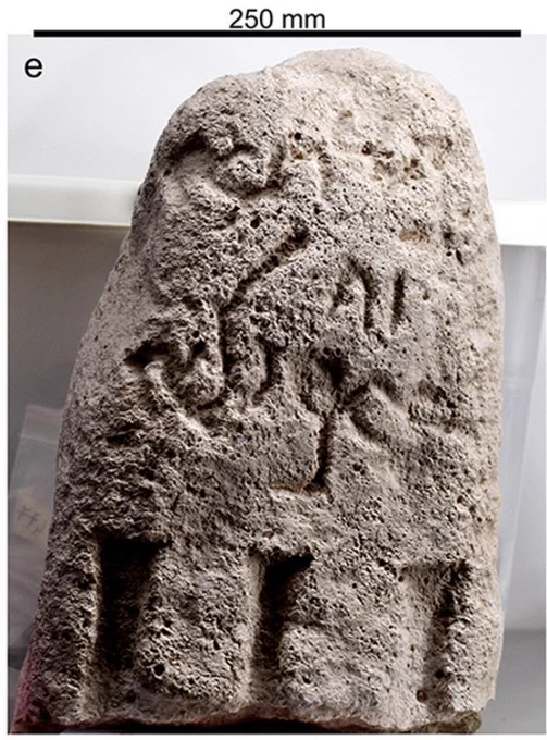 Piece of grey-brown stone engraved with an inscription in Aramaic.