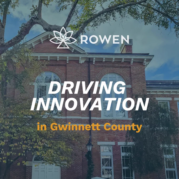 Rowen logo over an image of a classic brick building with the text 'Driving Innovation in Gwinnett County' beneath a clear blue sky.