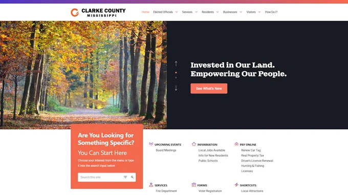 Clarke County website homepage with large forest photo, and a mix of orange and black text links