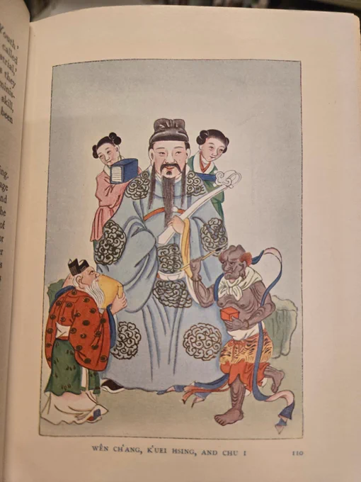 color illustration of a man with long beard in blue robe surrounded by 4 smaller attendants. Text at bottom reads "Wên Ch’ang, K’uei Hsing, and Chu I"