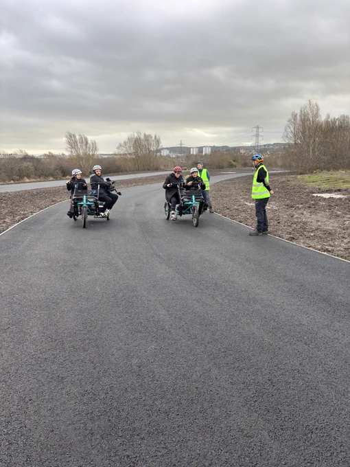 Camera crew on a tricycle filming our young person who is with presenter on other tricycle
