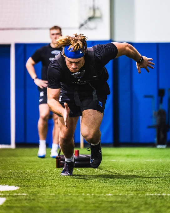 Jeremiah Hasley running and pulling a sled