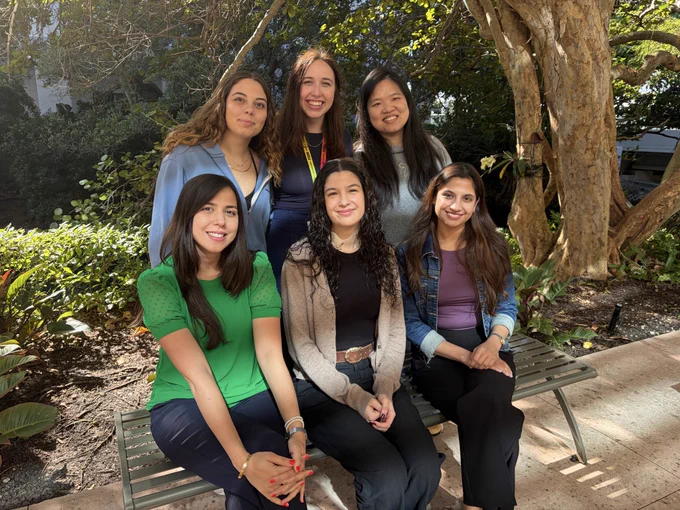 Group of 6 women smiling together outside