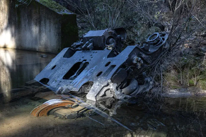 A huge piece of debris, seen by a photographer for The New York Times, appeared to have flown roughly 900 feet from the tracks, landing next to a stream running through a steep-sided gully below the railway.