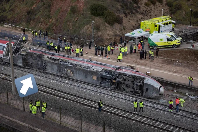 One of the crashed trains with what appears to be a section of the undercarriage missing.