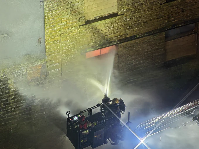 Aerial ladder platform directing jet onto fire through window