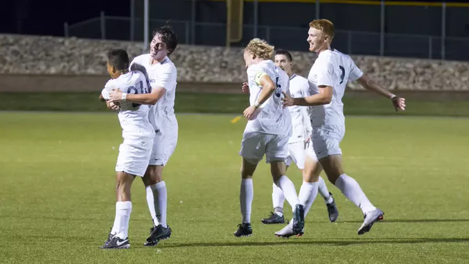 Jordyn McGrath is mobbed by his teammates after a goal