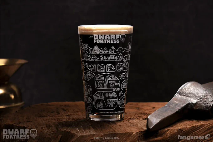 A photo of the Fortress Cross-Section pint glass filled with a dark, foamy liquid. It's standing on a rough wooden surface next to a pick. The Dwarf Fortress logo is printed near the rim, and a wraparound line illustration of a fortress. 