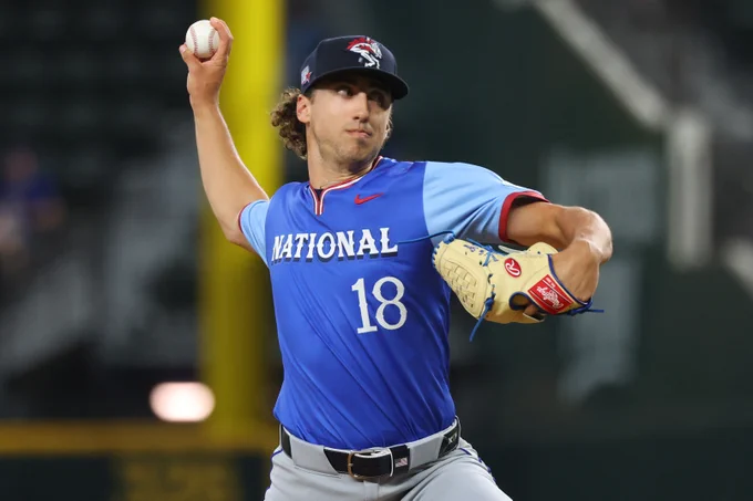 Brandon Sproat wears a blue uniform top with "National" and the number 18 on the front in white text.