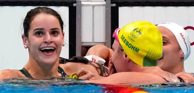 Backstroke swimmers at the end of a race