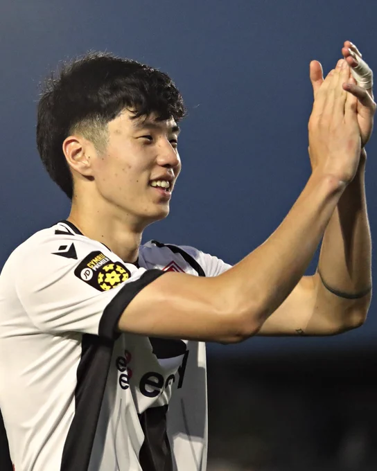 Isaac Lee applauds Flint Town United fans.