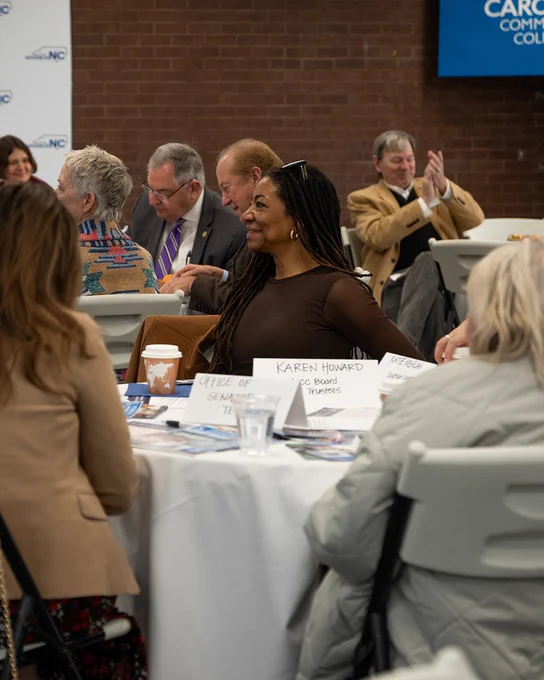 A group of people sitting at tables
