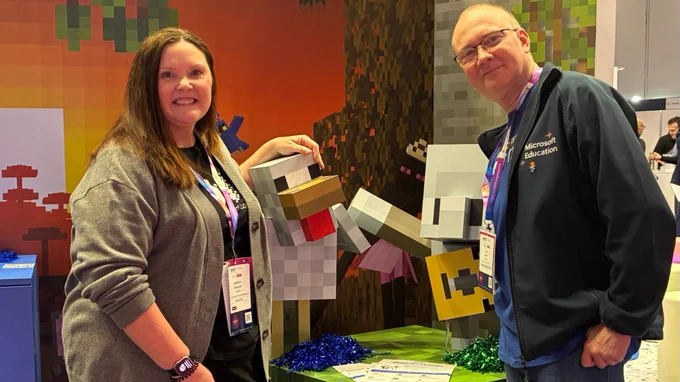 Two people posing in the Bett Minecraft Education photo booth