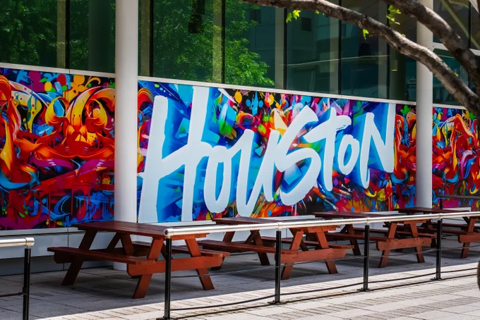 Colorful mural with the word "Houston" prominently displayed near the George R. Brown Convention Center.