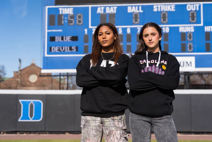 Ana Gold and Aleshia Ocasio pose at Duke in Carolina Blaze merchandise.