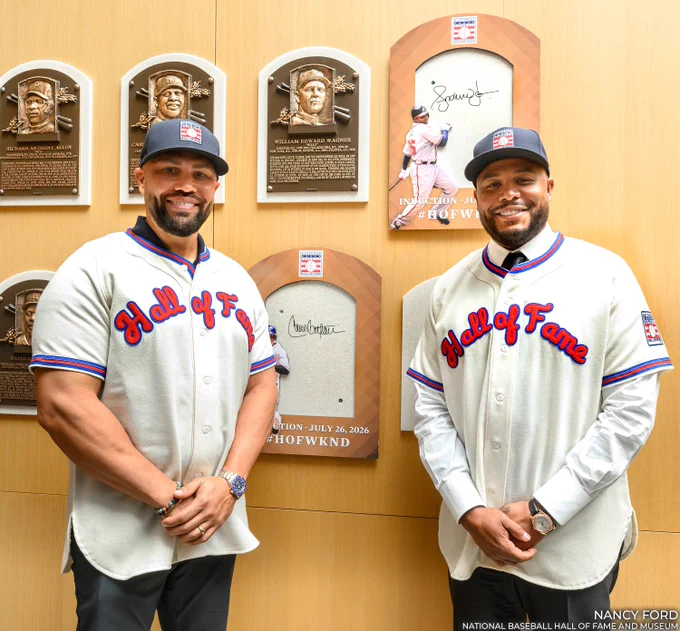 Carlos Beltrán, left, and Andruw Jones pose in Hall of Fame caps and jerseys at the site of their future plaques. (Nancy Ford/National Baseball Hall of Fame and Museum)