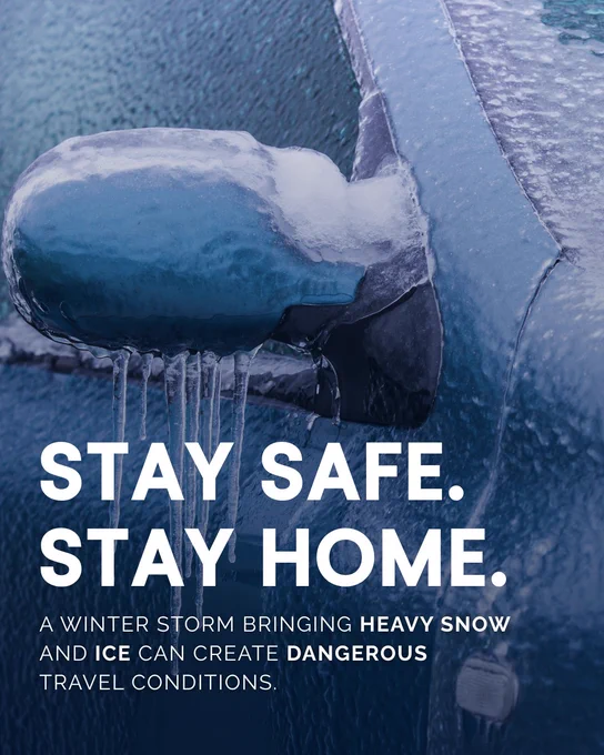 Promotional image featuring a car covered in ice and snow, with icicles hanging from the rearview mirror. Text overlay reads 'Stay Safe. Stay Home.' warning against dangerous travel conditions during winter storms.