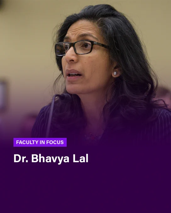 A woman is speaking in front of a small microphone. A purple gradient rises from the bottom of the image, where text reads FACULTY IN FOCUS Dr. Bhavya Lal 