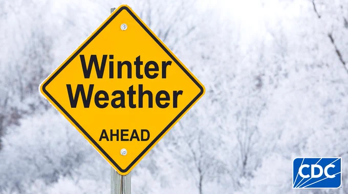 A yellow traffic sign displaying "Winter Weather AHEAD" with a snowy background.